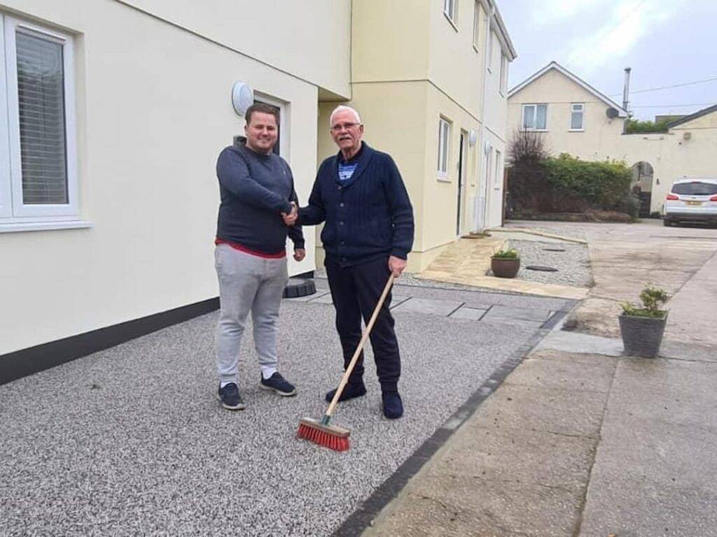 Shaking hands on a resin driveway